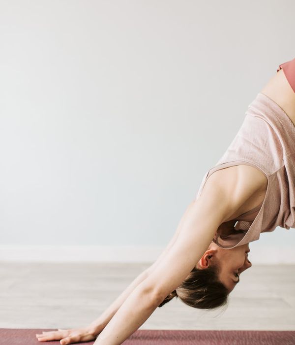 A serene woman in a yoga pose, looking calm and focused.